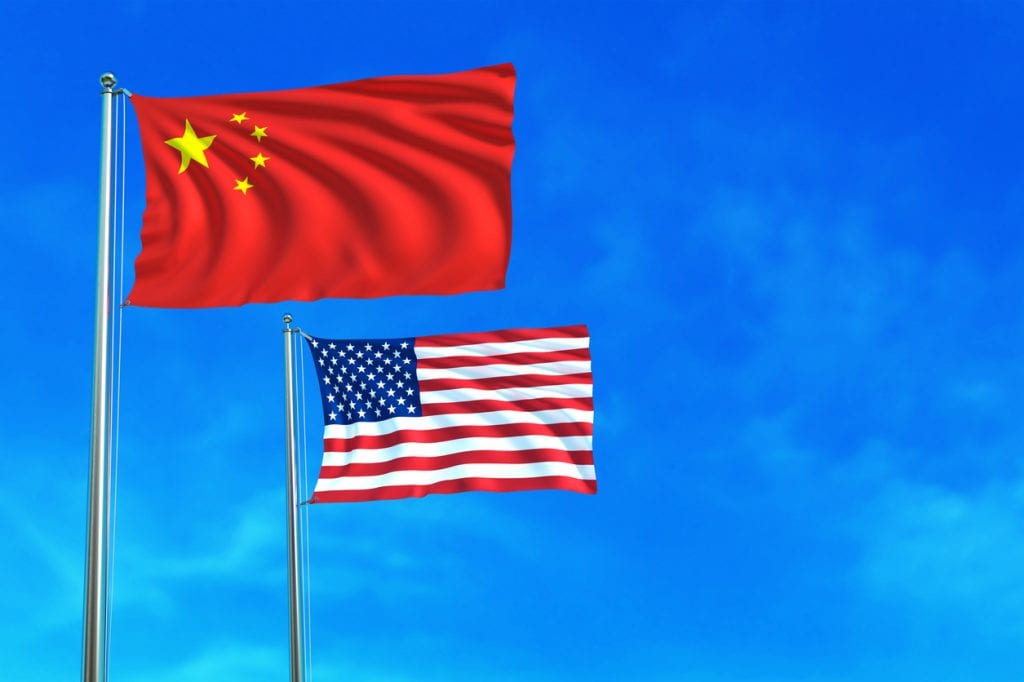 China and United States (USA) flags on the blue sky