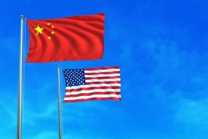 China and United States (USA) flags on the blue sky