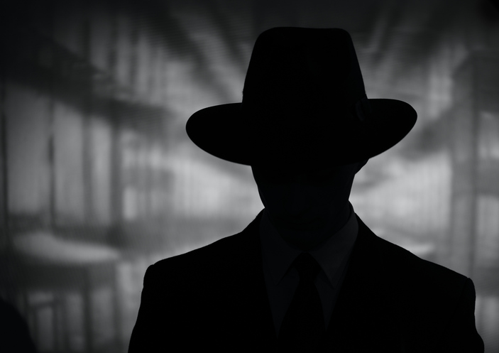 Silhouette of a mysterious man in a hat