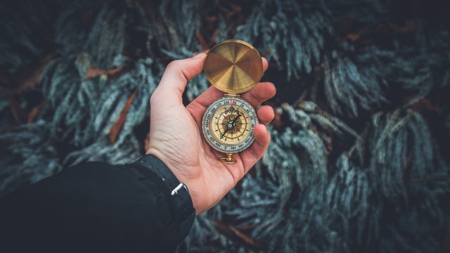 hand holding compass