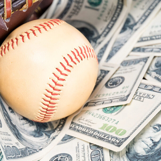 Closeup concept of baseball and money.