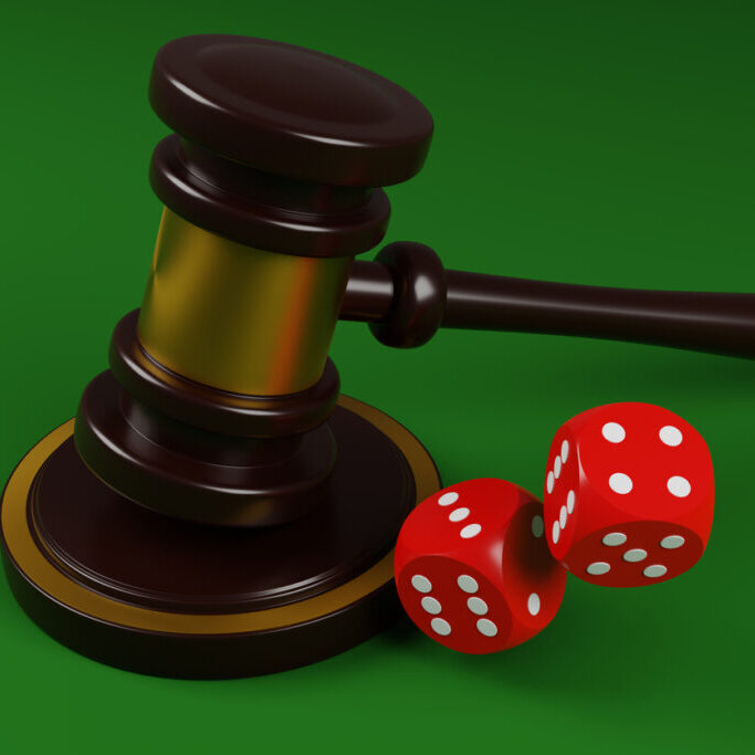 Red dice and judges gavel on a green background 3D render