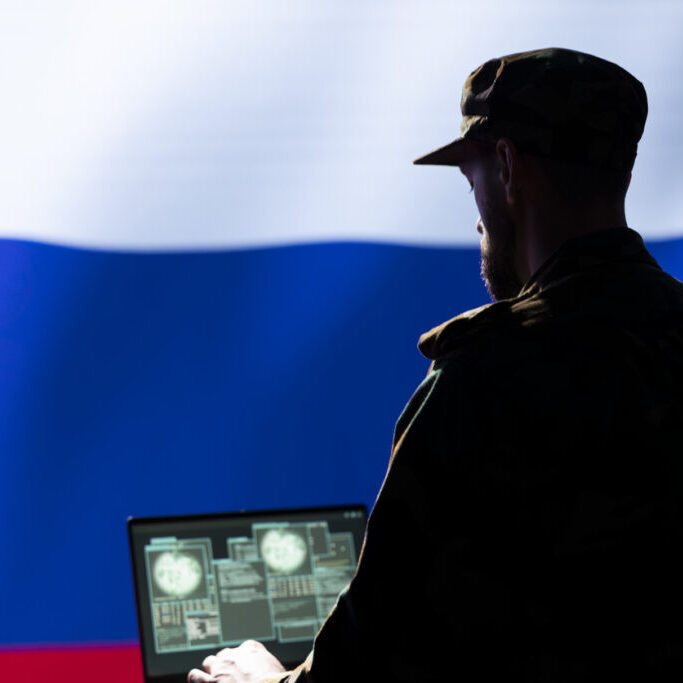 Ex KGB soviet agent combating organized crime and terrorism using detection system on laptop. Russia FSB officer protecting national sovereignty by tracking Chechen separatist terrorist