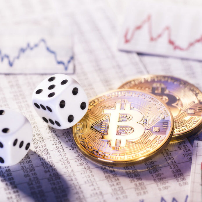 Frankfurt, Hesse, Germany - January 17, 2018: Two coins of crypto-currency Bitcoin with two dice
