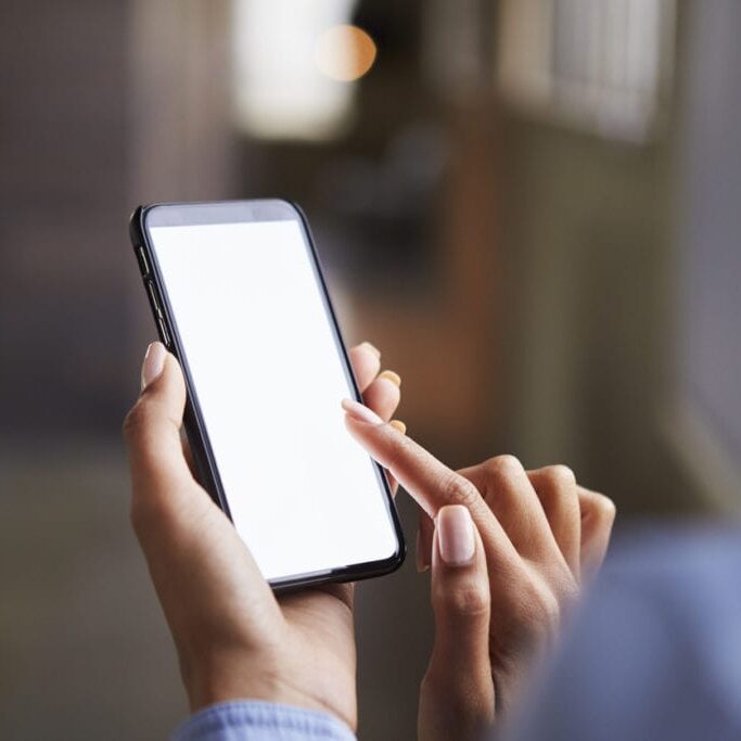 Close up of womanÕs hands using smartphone touchscreen