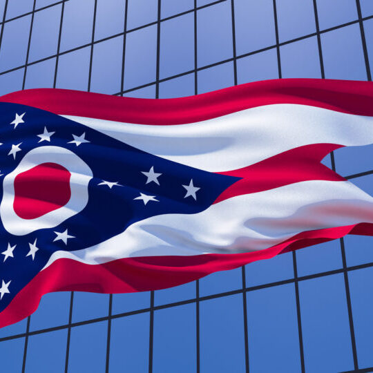 Ohio state state flag on skyscraper building background. 3d illustration