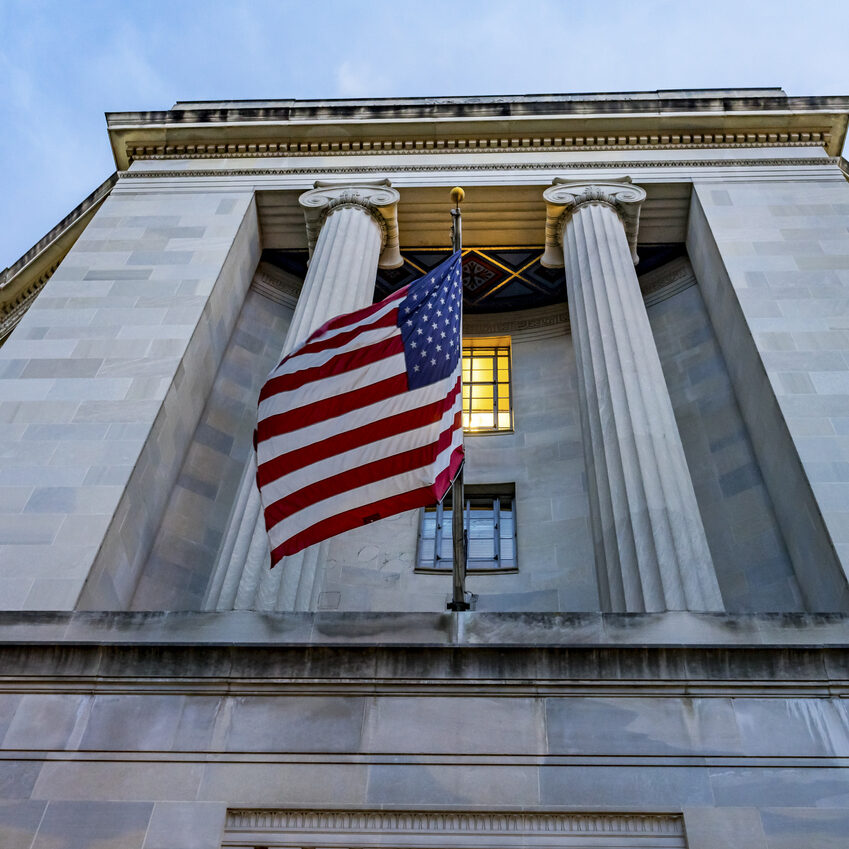 Facade FlagsJustice Department Building Pennsylvania Avenue Washington DC Completed in 1935. Houses 1000s of lawyers working at Justice.