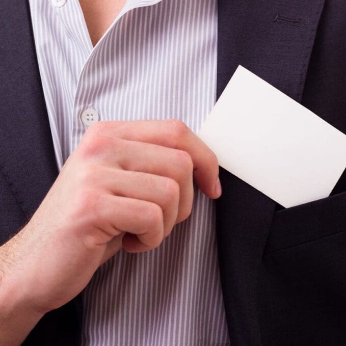 Businessman showing his business card, studio shot