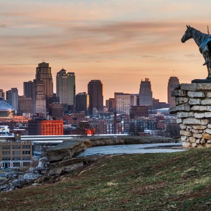 Kansas City, Missouri, USA on March 22, 2014.  A image of the Kansas City Scout overlooking Kansas City at sunrise.  The Indian Scout is known as a Kansas City landmark and symbol of the city. The scout overlooks the Kansas City Skyline.