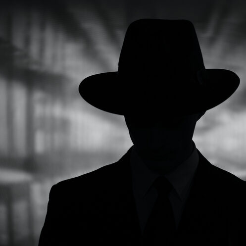 Silhouette of a mysterious man in a hat