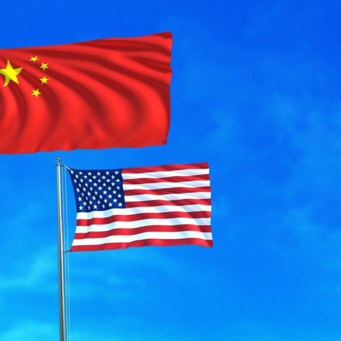 China and United States (USA) flags on the blue sky