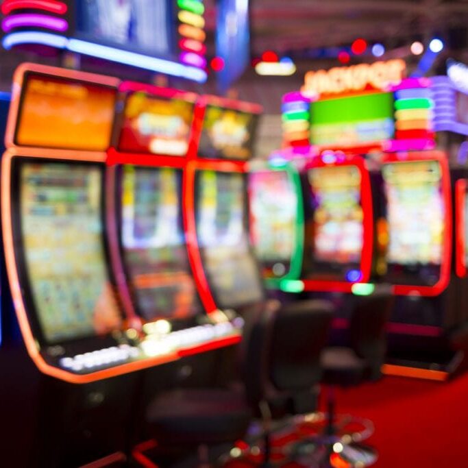 Blurred slot machines are seen in a casino. Out of focus blurry image of casino equipment.