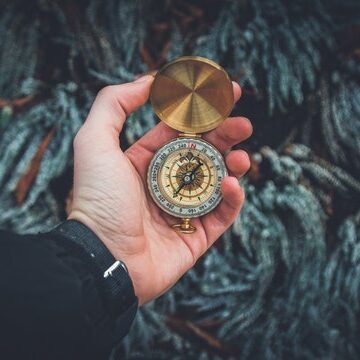 hand holding compass